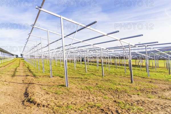 Metal framework on a field under a blue sky for solar systems, energy revolution, construction of PV open space, Baden-Württemberg, Germany