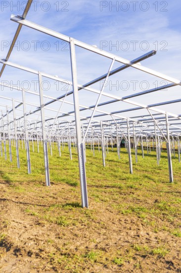 Empty metal frames on a field under a blue sky, Energiewende, construction of PV open space, Baden-Württemberg, Germany