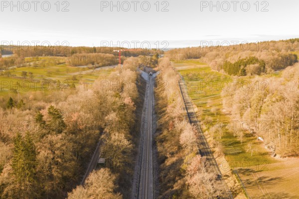 Train route from above, flanked by autumnal forests, running through nature, construction of the Hermann Hesse Railway, Calw, Germany