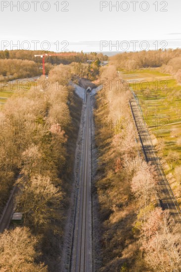 Aerial view of a train line through autumnal forests, parallel to a road, construction of the Hermann Hesse Railway, Calw, Germany