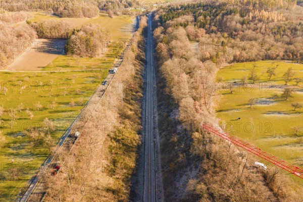 A railway cuts through fields and forests in a wintry countryside landscape, construction of the Hermann Hesse Railway, Calw, Germany