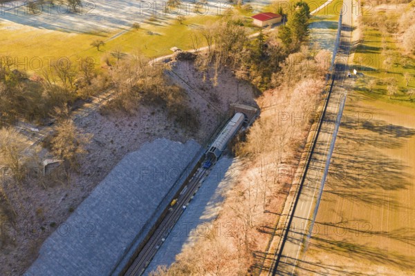Drone view of a railway line through an autumn landscape with meadows and forests, construction of the Hermann Hesse Railway, Calw, Germany