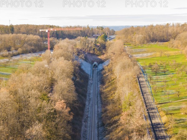 Aerial view of a railway tunnel surrounded by trees and meadows in autumn, construction of the Hermann Hesse Railway, Calw, Germany