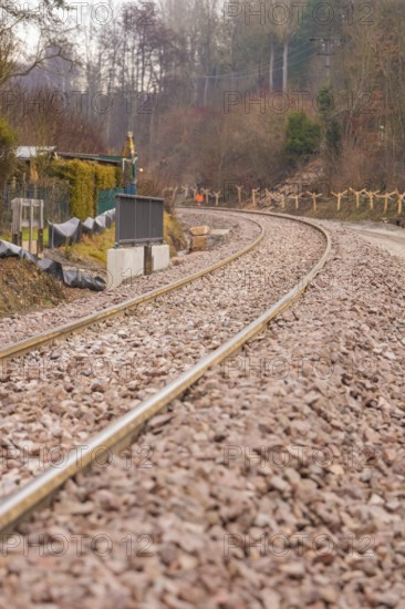 Railway tracks on a bend surrounded by gravel, along a wintry landscape, construction of the Hermann Hesse Railway, Calw, Germany