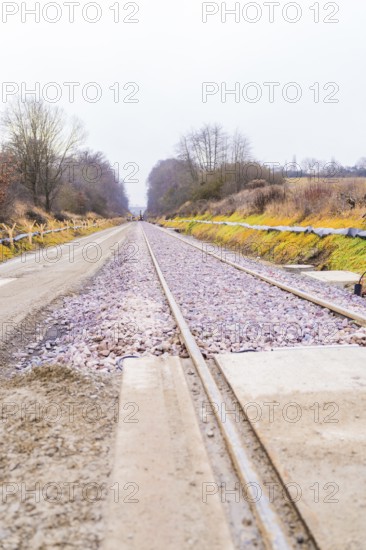 Railway tracks run in perspective through a cloudy landscape, construction of the Hermann Hesse Railway, Calw, Germany