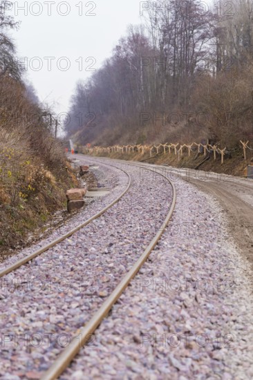 Curvy train tracks meander through a wooded, quiet landscape, built by the Hermann Hesse Railway, Calw, Germany