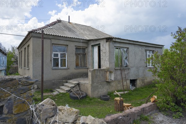Abandoned house with damaged windows and brick walls in a rural area, inhabited house, Sameba, Kvemo Kartli region, Lower Kartli, Georgia