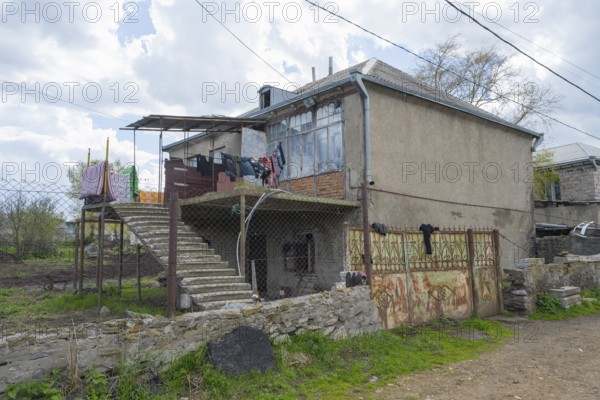 Rural building with external staircase, suspended clothing and adjacent wall, inhabited house, Sameba, Kvemo Kartli region, Lower Kartli, Georgia