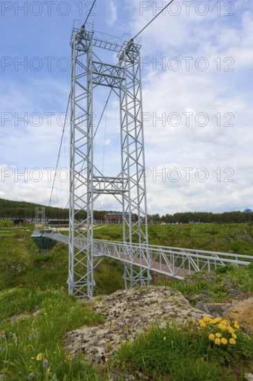 A modern suspension bridge over a green landscape with wildflowers, diamond bridge, Diamond Glass Bridge, world's longest free-hanging structure, Dashbashi Gorge, Khrami River, Chrami, Tsalka Nature Reserve, Kartli, Georgia