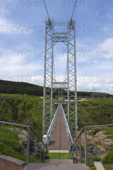 View of a high suspension bridge with steel girders against the blue sky, Diamond Bridge, Diamond Glass Bridge, world's longest free-hanging structure, Dashbashi Gorge, Khrami River, Tsalka Nature Reserve, Kartli, Georgia