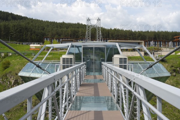 View from a modern glass bridge surrounded by forest and buildings, Diamond Glass Bridge, world's longest free-hanging structure, Dashbashi Gorge, Khrami River, Chrami, Tsalka Nature Reserve, Kartli, Georgia