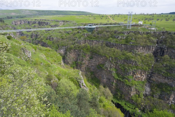 Suspension bridge stretches over a deep, green gorge with surrounding nature, Diamond Bridge, Diamond Glass Bridge, world's longest free-hanging structure, Dashbashi Gorge, Khrami River, Tsalka Nature Reserve, Kartli, Georgia