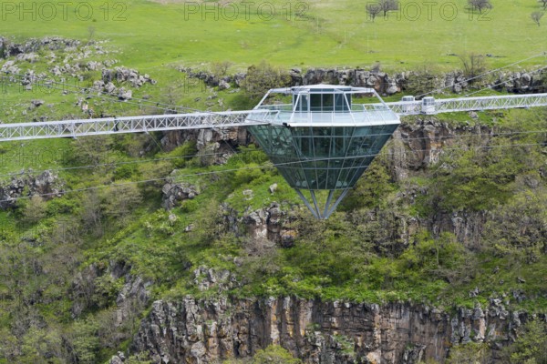 A glass bridge floats over a rocky and green gorge, Diamond Glass Bridge, world's longest free-hanging structure, Dashbashi Gorge, Khrami River, Chrami, Tsalka Nature Reserve, Kartli, Georgia