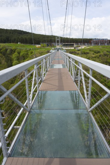 A modern suspension bridge with glass floor stretches across a green gorge, Diamond Bridge, Diamond Glass Bridge, world's longest free-hanging structure, Dashbashi Gorge, Khrami River, Tsalka Nature Reserve, Kartli, Georgia