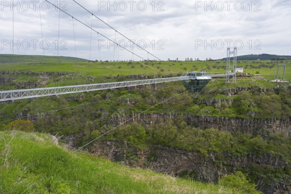 Long glass bridge spanning green landscape and gorge, diamond bridge, Diamond Glass Bridge, world's longest free-hanging structure, Dashbashi Gorge, Khrami River, Tsalka Nature Reserve, Kartli, Georgia