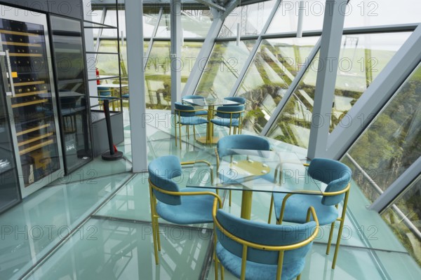 A modern café with glass floors and blue chairs offers impressive views, Diamond Bridge, Diamond Glass Bridge, world's longest free-hanging structure, Dashbashi Gorge, Khrami River, Chrami, Tsalka Nature Reserve, Kartli, Georgia