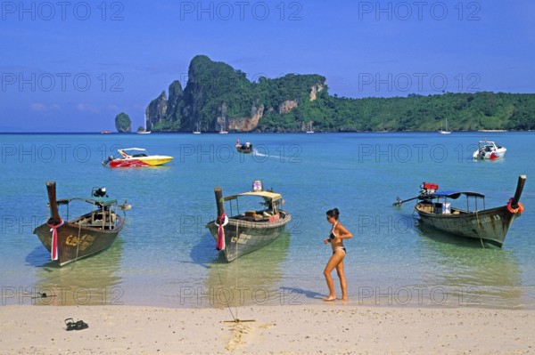 Young woman, longtail boats on the beach of Ko Phi Phi Don, two years in front of the tsunami, Thailand, December 2002, vintage, retro, old, historic