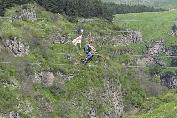 Adventurous bicycle ride on a rope through a distinctive rocky landscape, Dashbashi Gorge, Khrami River, Tsalka Nature Reserve, Kartli, Georgia