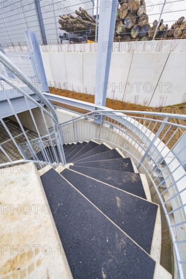 Downward spiral of steel and concrete staircase, showing modern building style, parking garage construction with charging infrastructure, Calw, Germany