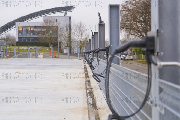 Row of charging stations with a modern building in the background, parking garage construction with charging infrastructure, Calw, Germany