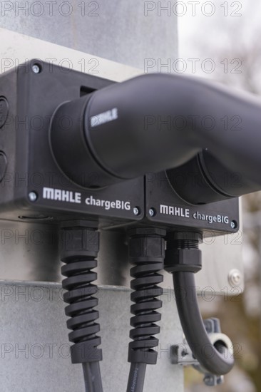 Close-up of charging stations with two black cables, mounted on metal, parking garage construction with charging infrastructure, Calw, Germany