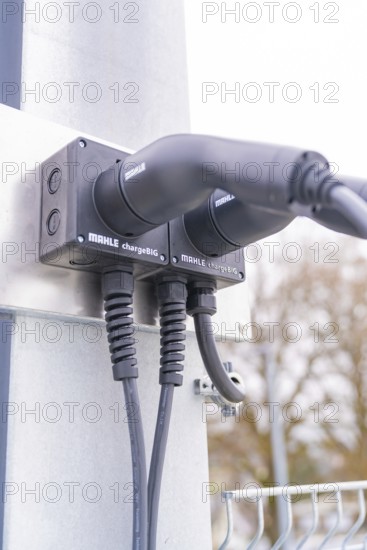 Modern electric charging station with cable connections on metal, parking garage construction with charging infrastructure, Calw, Germany