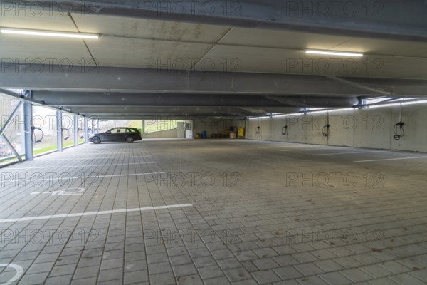 Empty parking garage with marked parking spaces and lighting, parking garage construction with charging infrastructure, Calw, Germany