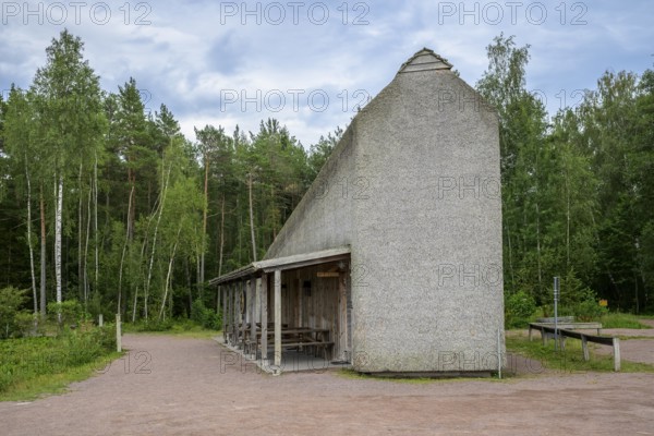 Naturum Nature Conservation Information Center at Vogelsee Tåkern, modern outbuilding with pitched roof and rest areas built entirely of reed thatch next to a large reed tree, Tåkern, Vadstena, Östergötalands Län, Sweden