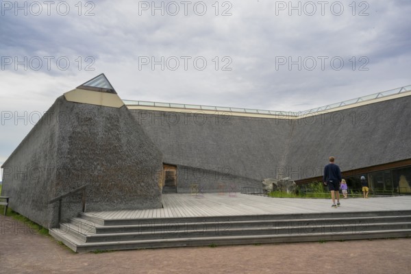 Naturum Nature Conservation Information Center at Vogelsee Tåkern, modern building with pitched roof made entirely of reed thatch next to a large reed tree, Tåkern, Vadstena, Östergötalands Län, Sweden