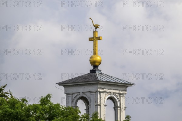 Ödeshög church tower with golden cross and weather swan Swan rising into the sky, near Tåkern, Vadstena, Östergötalands Län, Sweden