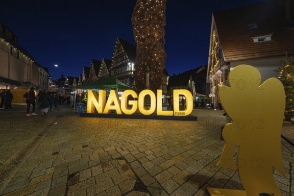 Large glowing decoration with the lettering 'Nagold' on a nocturnal town square, Weihnachtsmark Nagold, LandkreisCalw, Germany