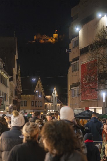 Nighttime scene with crowd and illuminated castle in the background, Weihnachtsmark Nagold, LandkreiScalw, Germany