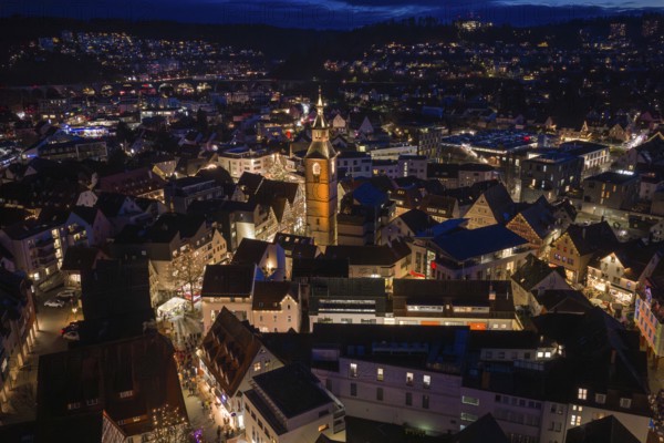 Nocturnal aerial view of a city with an illuminated church and illuminated buildings, Weihnachtsmark Nagold, Landkreis Calw, Germany