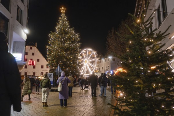 Night view at a Christmas market with illuminated tree and Ferris wheel, Weihnachtsmark Nagold, LandkreisCalw, Germany