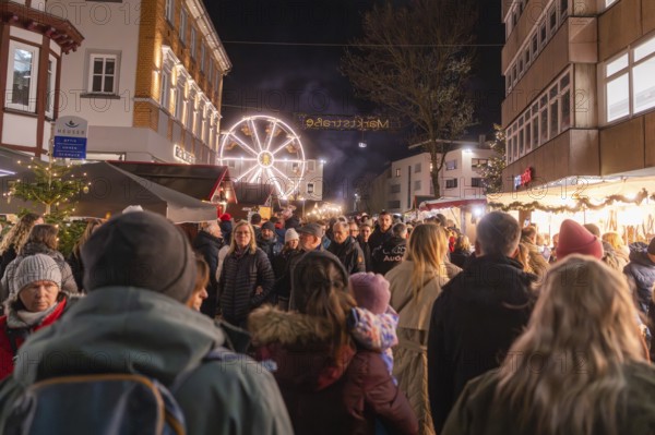 Busy night market with glowing Ferris wheel and crowd, Weihnachtsmark Nagold, LandkreiScalw, Germany