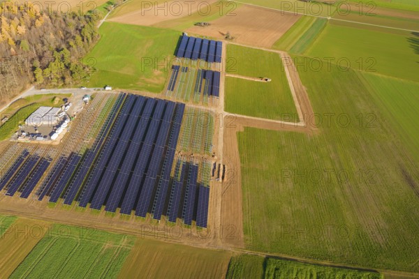 Extensive solar system in the midst of green and autumnal fields from the air, energy revolution, construction of PV open space, Baden-Württemberg, Germany