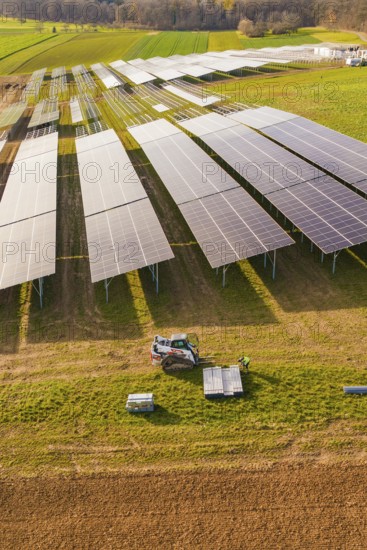 Workers install solar panels in fields with agricultural technology, energy transition, construction of PV open space, Baden-Württemberg, Germany