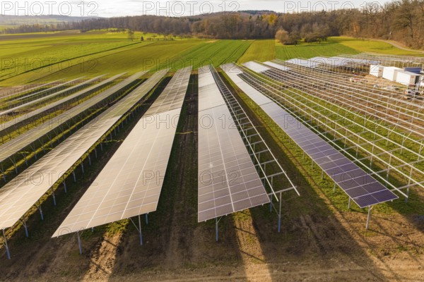 Rows of solar panels arranged in green fields, energy revolution, construction of PV open space, Baden-Württemberg, Germany