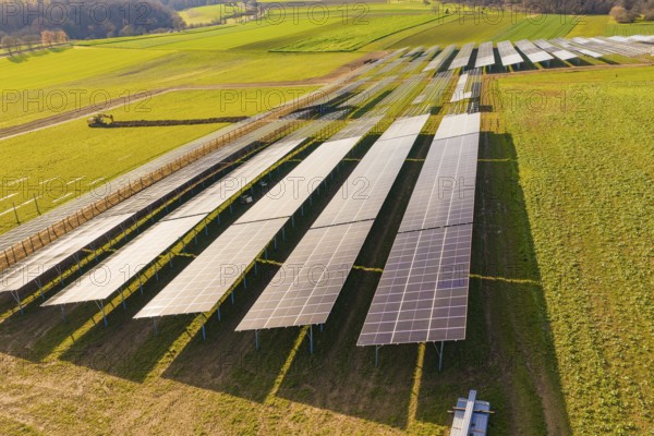 Aerial view of large solar systems on green fields in a rural landscape, energy transition, construction of PV open space, Baden-Württemberg, Germany