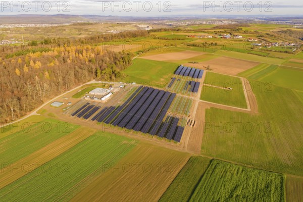 Aerial view of a solar field with autumn surroundings in a rural region, energy transition, construction of PV open space, Baden-Württemberg, Germany