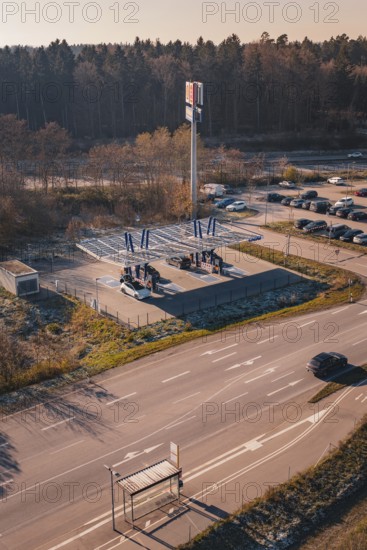 Charging station with electric car near a forest, quiet surroundings with sunset and autumn flair, ENBW charging park, Rutesheim, Germany