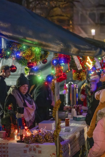 Christmas market with decorated stands and glowing lights, surrounded by people in a festive mood, Christmas market, Aidingen, Germany