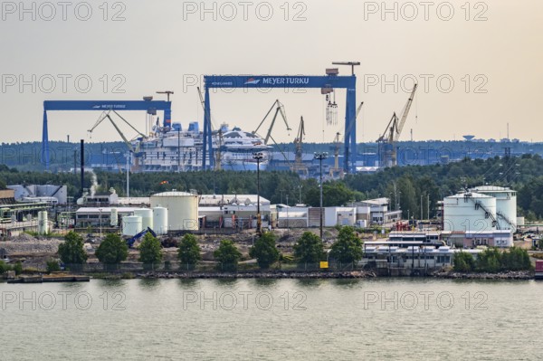 Industrial harbor scene with cranes and shipyards on the water, Meyer Werft, Turku, Finland