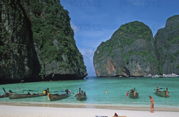 People, longtail boats on Maya Bay beach, known from the movie The Beach, one year in front of the tsunami, Ko Phi Phi Le, Thailand, December 2002, vintage, retro, old, historic