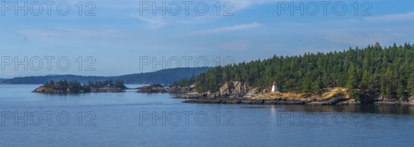 Passengers traveling by ferry from vancouver to victoria, british columbia, enjoying scenic views of rugged coastlines, lighthouses, and tranquil blue waters