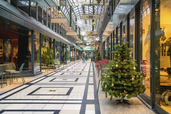 Christmassy decorated and modern shopping arcade with glass roof, Calwer Passage, Stuttgart, Germany