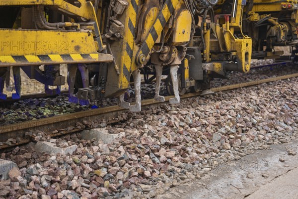 Close-up of technical devices working on train tracks, tamping machine on Hermann, Hesse, Bahn, Althengstett, Calw district, Germany