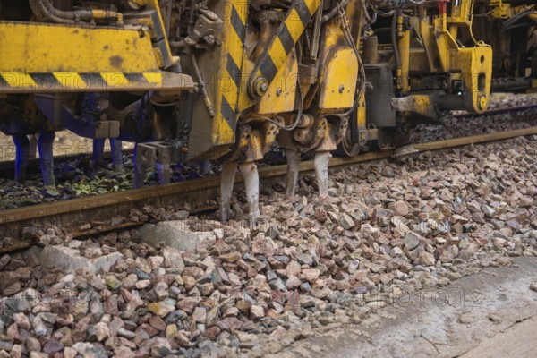 Detailed view of a track construction machine working on a layer of ballast, tamping machine on Hermann, Hesse, Bahn, Althengstett, Calw district, Germany