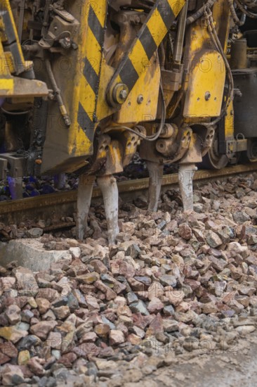 Detailed view of a gravel and track construction machine with yellow-black painting, stuffing machine on Hermann, Hesse, railway, Althengstett, Calw district, Germany