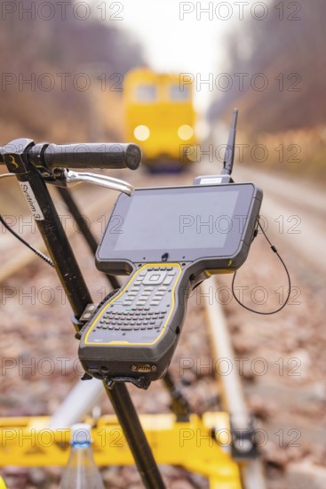 A technical device with a screen on a rail surveyor in the blur of the background, stuffing machine on Hermann, Hesse, Bahn, Althengstett, Calw district, Germany
